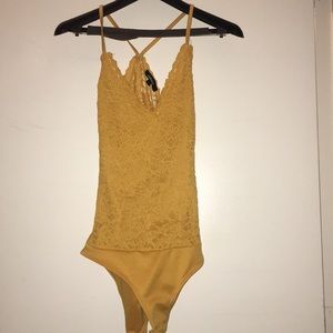 Mustard yellow lace body suit.